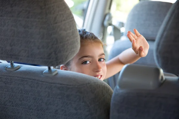 Kid girl happy greeting gesture hand in car indoor