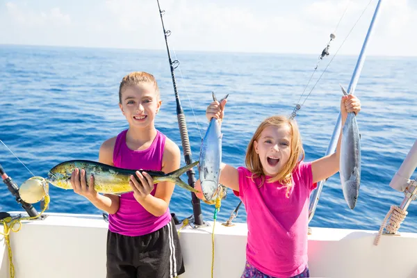 Happy tuna fisherwomen kid girls with fishes catch