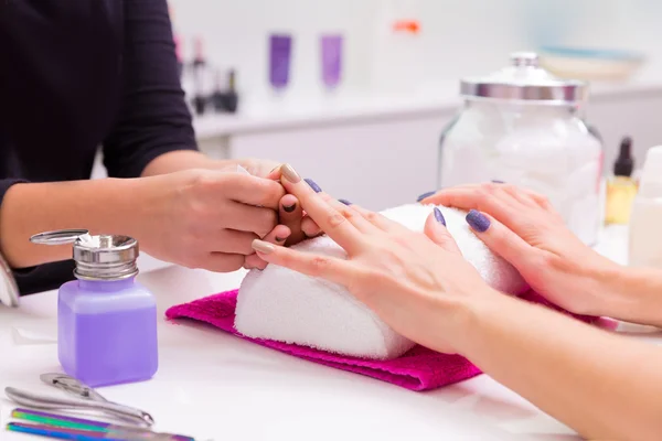 Nails saloon woman nail polish remove with tissue