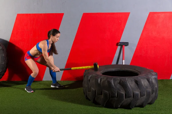 Sledgehammer Tire Hits woman workout at gym