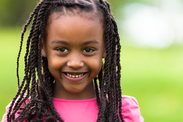 Outdoor close up portrait of a cute young black girl - African p