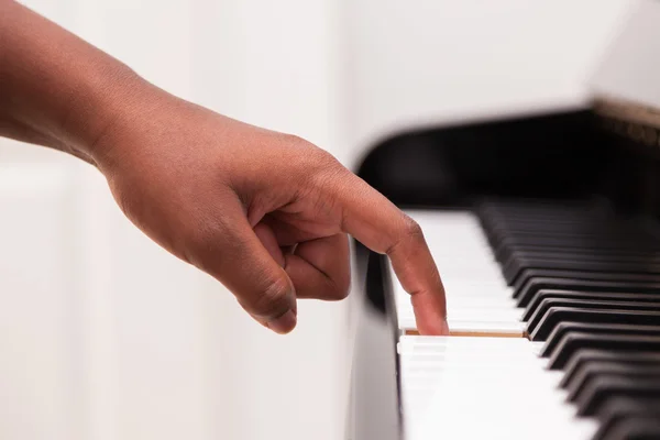 African American hand playing piano - Touching piano keys - Blac