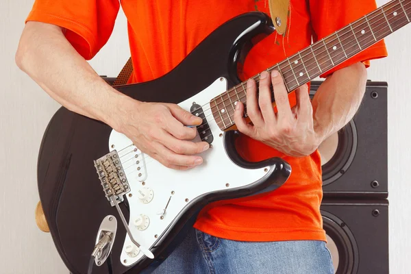 Hands of rock guitarist playing guitar