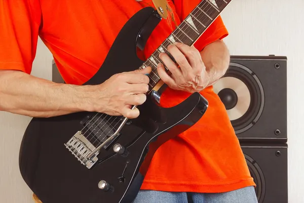 Hands of the rock musician playing the electric guitar