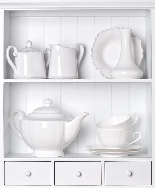 White shelf with vintage porcelain tableware