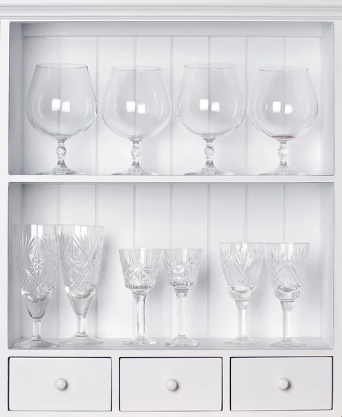 White shelf with vintage crystal glasses