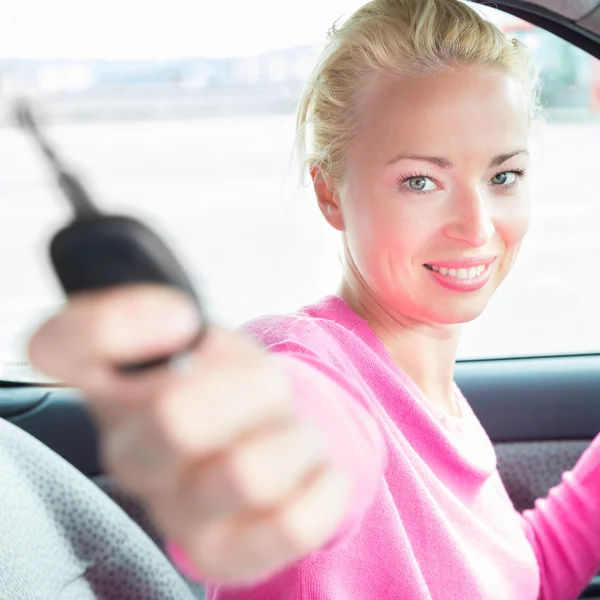 Woman driver showing car keys.