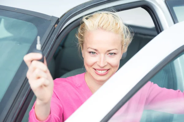 Woman driver showing car keys.