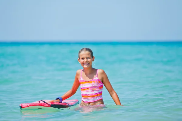 Girl has fun with the surfboard