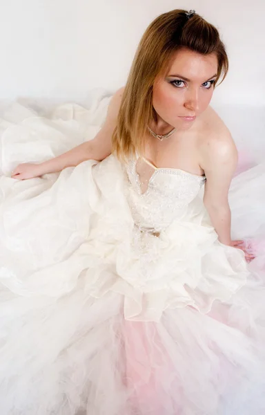 Young lady in bridal dress in studio