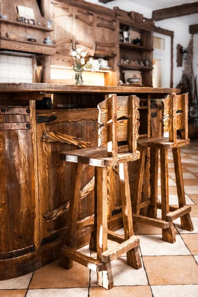 Two high wooden bar chairs in country style