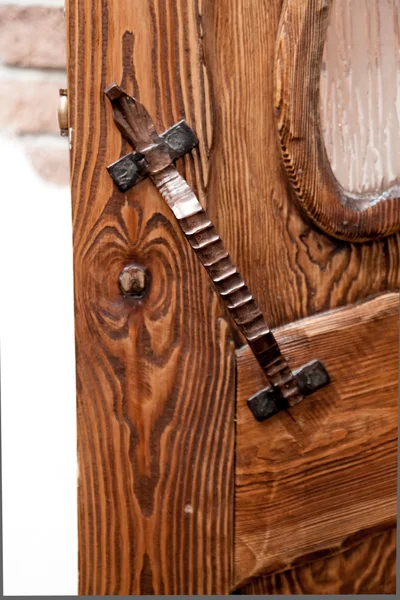 Metal door handle on wooden door