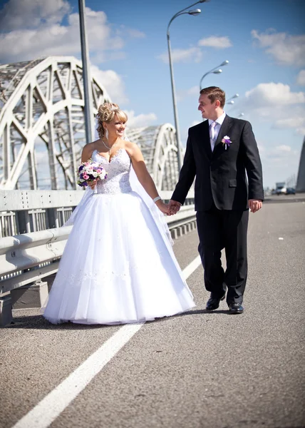 Newly married couple walking on road