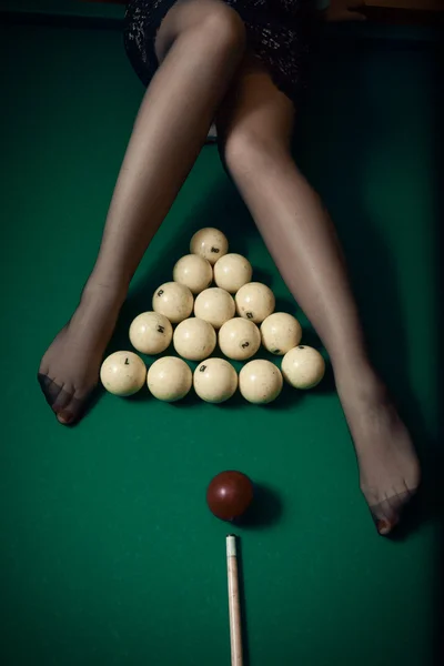 Billiard ball aiming at sexy women legs in stockings