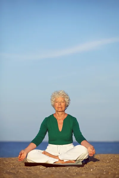 Senior woman practicing morning yoga