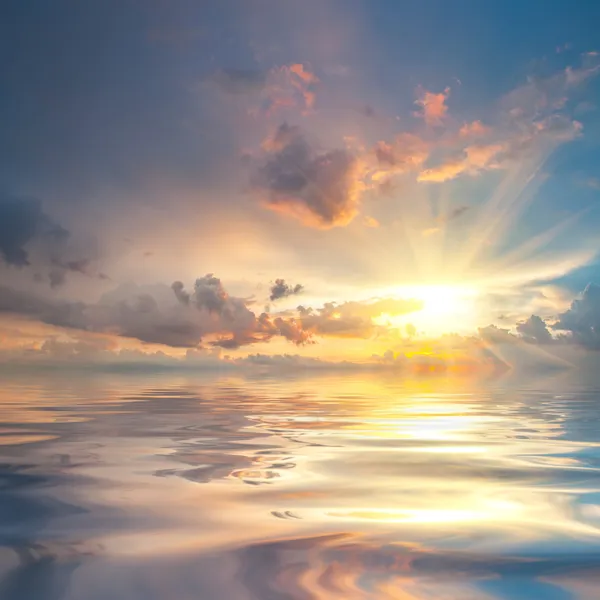 Sunset over sea with reflection in water