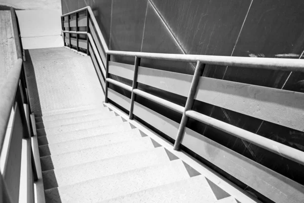 Industrial metal staircase perspective. Black and white photo