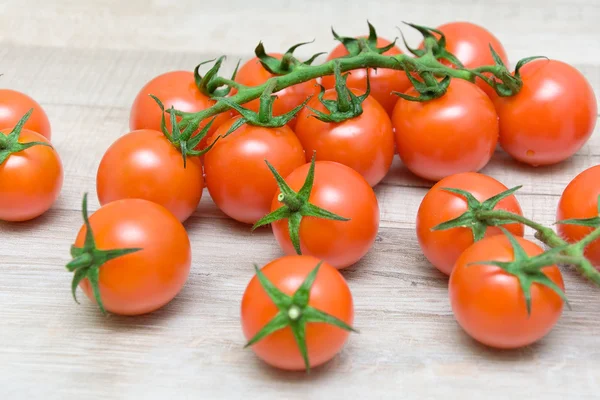 Cherry tomatoes on wooden background closeup