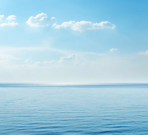 Blue sea and clouds on sky