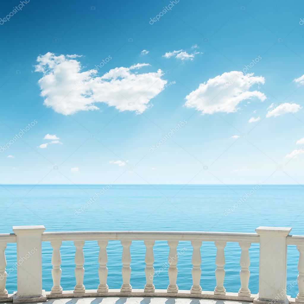 View to the sea from a balcony under cloudy sky wall mural *.