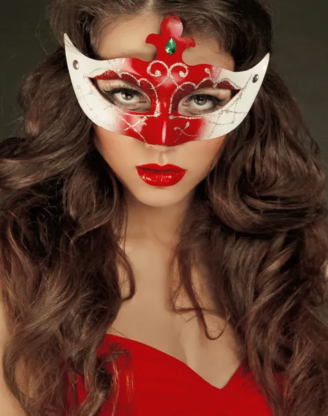 Beautiful Girl in Carnival mask with long curly hair. Masquerade