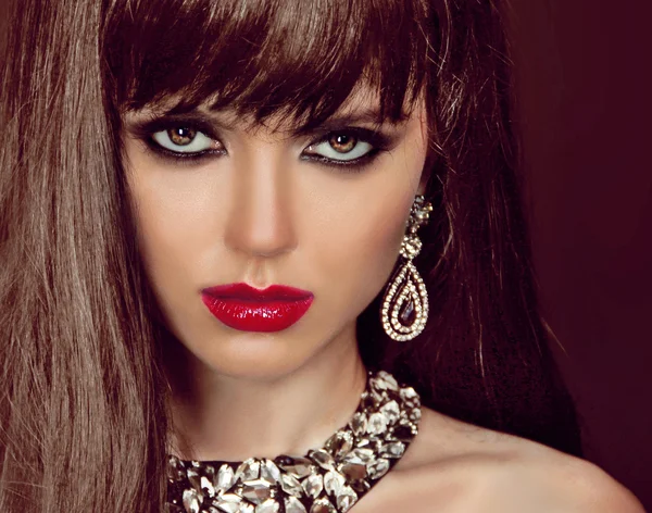 Fashion woman with brown hair and evening make-up. Jewelry and B
