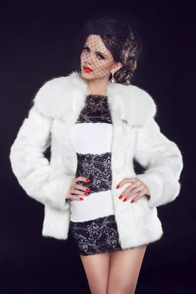 Fashion model woman wearing in luxury fur coat and elegant dress