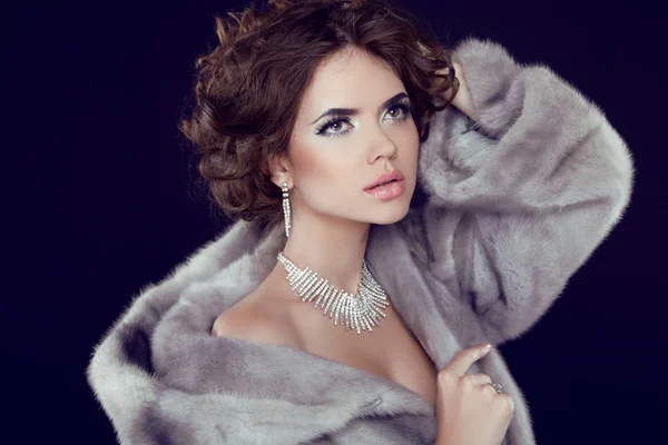 Fashion Model Girl Portrait with jewelry wearing in grey mink fu