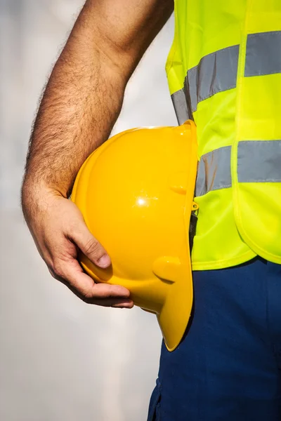 Man holding yellow helmet close up