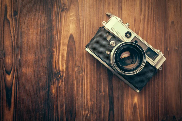 Vintage camera on wooden background