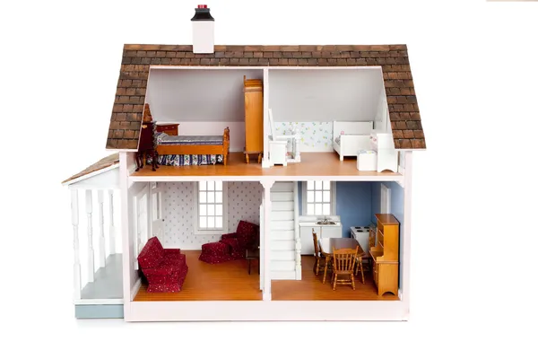 Child's doll house with furniture on white