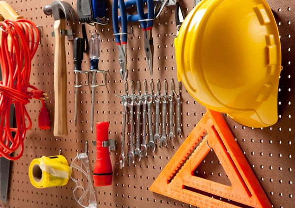 Peg board with tools and hard hat