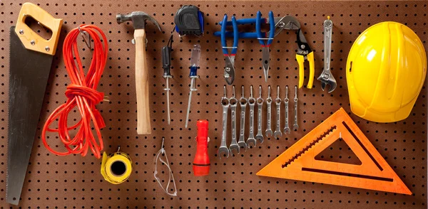 Peg board with tools and hard hat