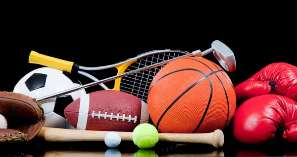 Assorted sports equipment on black