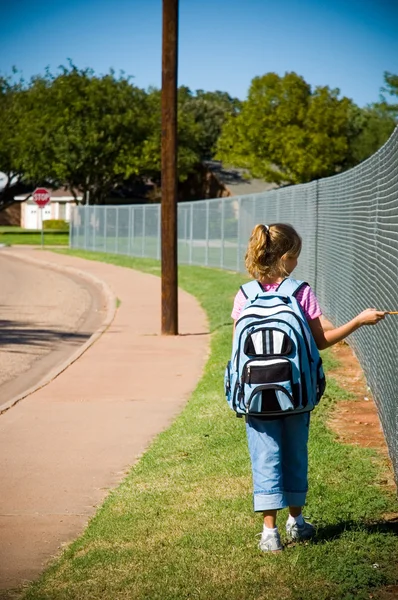 Young girl walking to school on first day of school