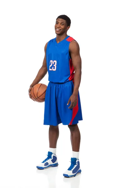 A young African American basektball player in uniform