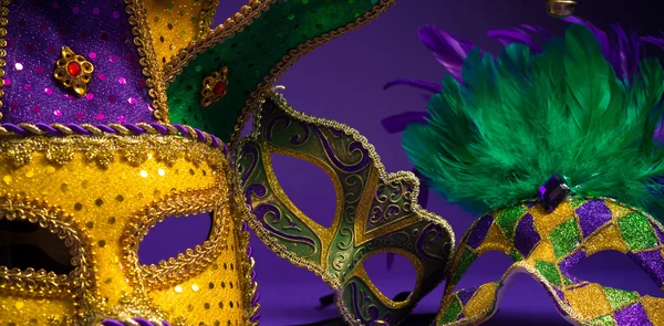 Assorted Mardi Gras or Carnivale mask on a purple background