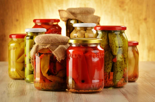 Composition with jars of pickled vegetables. Marinated food