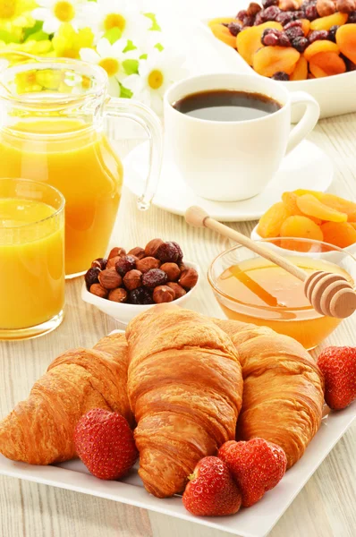 Breakfast with croissants cup of coffee and fruits