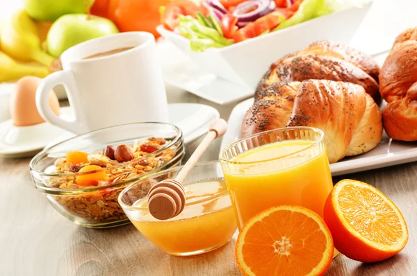 Breakfast including coffee, bread, honey, orange juice, muesli a