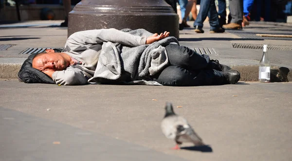 Homeless man sleeping on the street in Paris