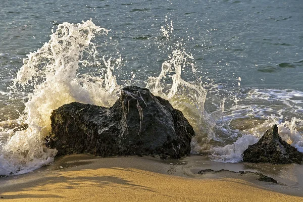 Wave breaking on a rock
