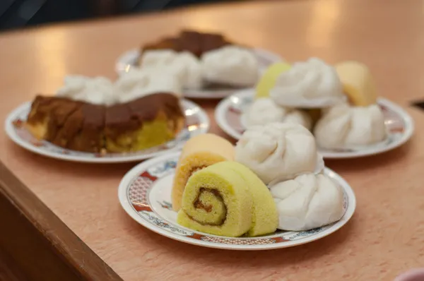 Yam roll and cake on dish on table