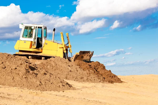 Bulldozer moving soil at construction site