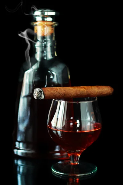 Glass and bottle with cognac