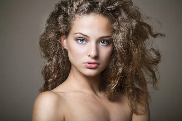 Beautiful sexy young woman with curly hair