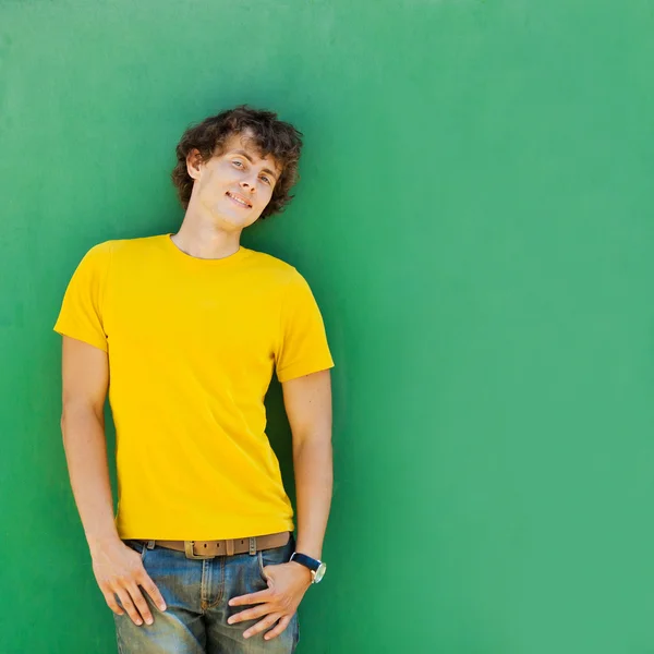 Young man on green background