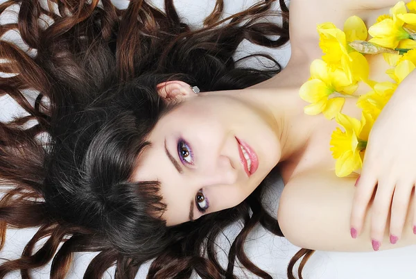Portrait beautiful girl with long hair with narcissus