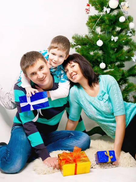 Young family having fun under the Christmas tree