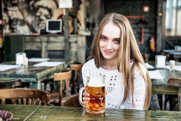 beautiful woman drinking beer at the cafe